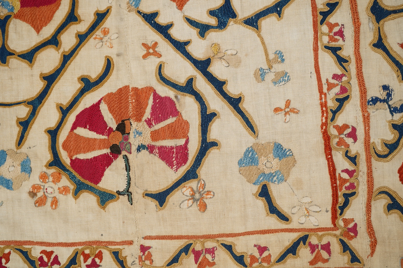A 19th century Uzbekistan Suzani, hand embroidered hanging. Made from hand woven linen panels each approximately 28cm wide x 167cm long. Hand embroidered with silk hand dyed threads, in orange, red, blue and yellows, usi